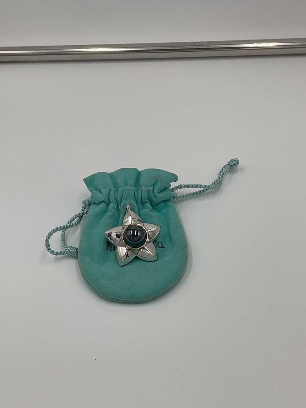 Tiffany & Co. Silver, Gold, and Onyx Star Pendant